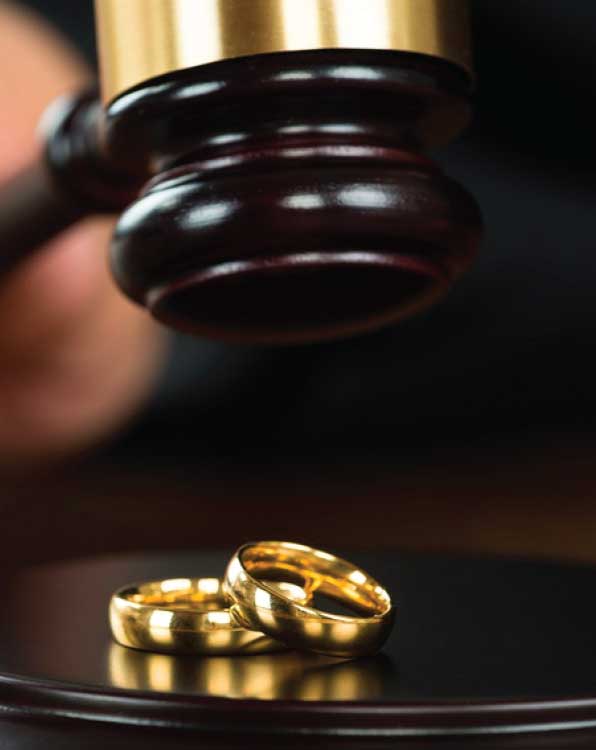 Gavel over wedding rings representing family and divorce law
